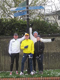 Paul, Richard, Warren and Elaine gathered around a signpost